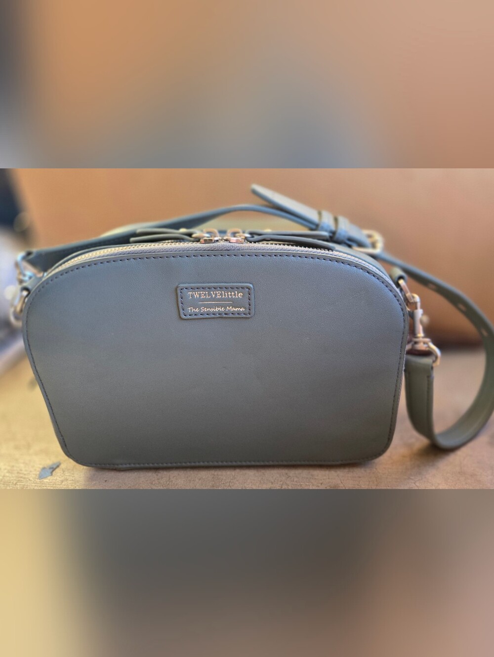 This is a TWELVElittle x The Sensible Mama Clutch in a muted blue vegan leather.